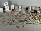an assortment of gold and silver jewelry including rings, bracelets, rings, and earrings