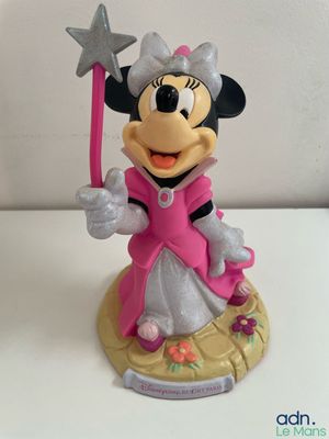 minnie mouse figurine holding a wand and wearing a pink dress