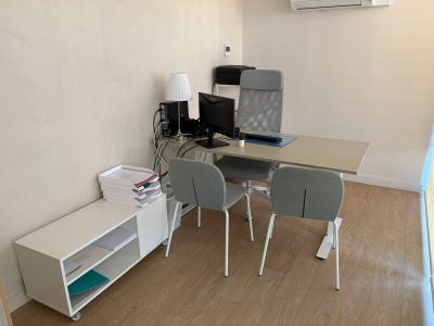 a desk with two chairs and a computer on top of it