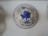 a blue and white plate with a blue flower on it