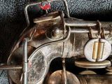 a close up of a silver saxophone with a red button on it