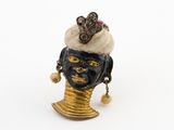 une image représentant une figurine de femme portant un chapeau sur la tête