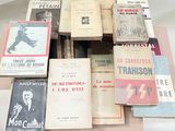 a lot of books on a table that are on top of each other