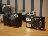 two cameras sitting on a table next to each other