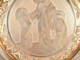 a gold plate with a picture of a man and a woman on it