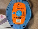 a close up of a blue and orange device on the ground