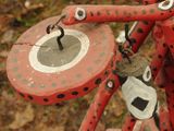 a close up of a red bicycle with a clock on it