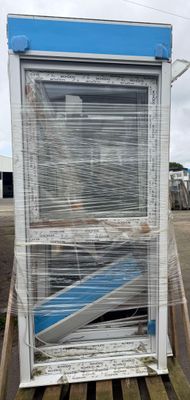 a broken window sitting on a pallet in a parking lot