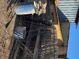 a pile of wood sitting on the ground outside of a building