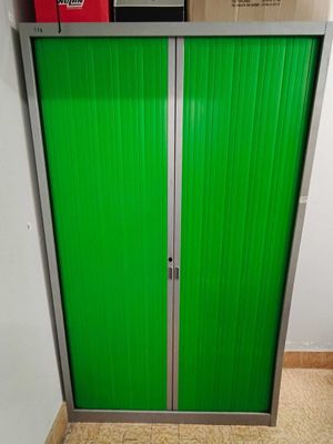 a green door that is open in a room