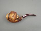 a picture of a wooden pipe holder with a cat on it