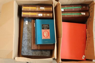 two boxes with books in them sitting on a table