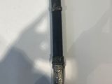 a close up of a baseball bat on a table with a shadow on the wall