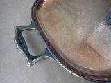 a large metal pan with a handle on a table