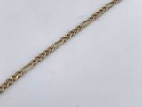 a close up of a gold chain with a knot on it