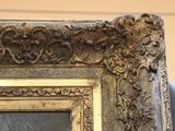 a picture of a gold frame with a picture on it