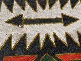 a close up of a piece of cloth with an arrow on it