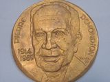 une pièce d'or sur laquelle figure l'image d'un homme