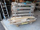 a wooden pallet with tools on it in a garage
