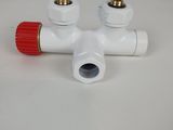 a close up of a red and white valve on a white table