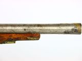 a close up of a gun with a wooden barrel on a white background