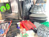 a pile of toy train tracks and other toy trains