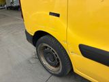 a yellow van that is parked in a parking lot