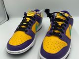 a pair of purple and yellow sneakers on a white surface