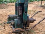 an old machine that is sitting in the grass