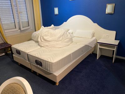 a bed with a mattress in a room with blue walls