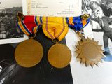 two medals on a table next to an old photo