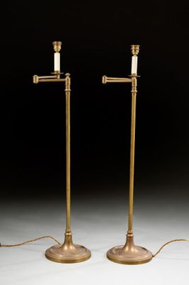 a pair of brass plated floor lamps