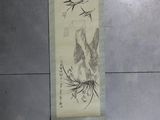 a scroll hanging on the wall with a painting on it