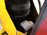 a close up view of the engine of a yellow vehicle