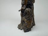 bronze statue of a man with a dog on a white background