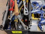 many tools in a tool box on the floor