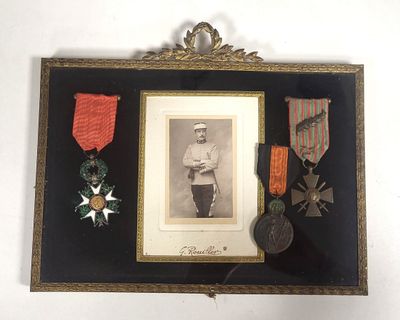 an old picture of a framed picture of a man with medals and medals