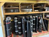 many rolls of black material on a shelf