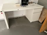a white desk with a printer on it in a room