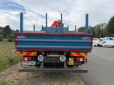 a blue and red truck parked on the side of the road