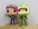 two toy figurines that are standing next to each other