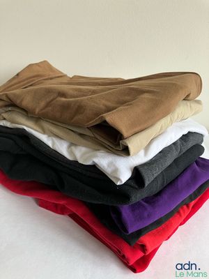 a lot of different colored shirts stacked on top of each other