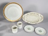 a white plate and cups and saucers on a table