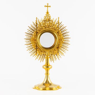 a golden chalicet with a cross on top of it