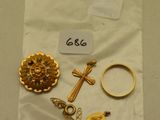 un gros plan sur un sac contenant des bijoux en or orné d'une croix