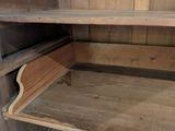a wooden cabinet with a shelf on the bottom