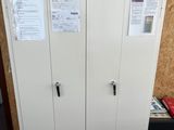 a picture of a white cabinet with a bunch of papers on it