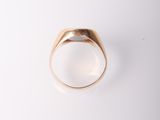 a close up of a gold ring with a white background
