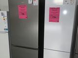 three refrigerators that are lined up in a room