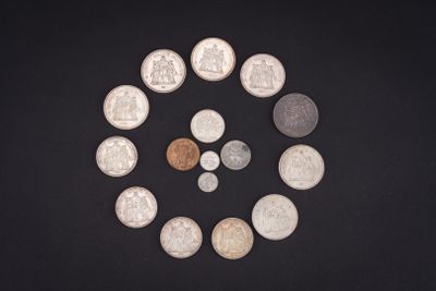 a lot of coins arranged in a circle on a black surface